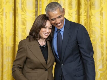 Former President Barack Obama hugs Vice President Kamala Harris during an Affordable Care