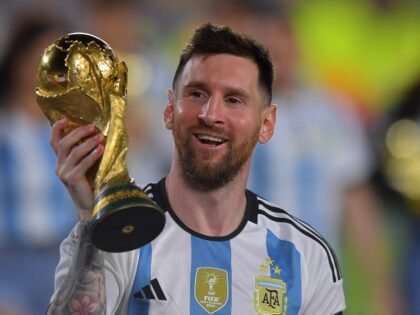 Lionel Messi of Argentina celebrates with the FIFA World Cup trophy during celebrations af