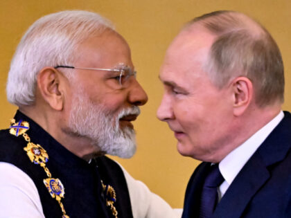 Russian President Vladimir Putin decorates Indian Prime Minister Narendra Modi with the Or