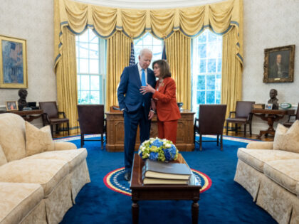 President Joe Biden talks with former Speaker of the House Nancy Pelosi, Tuesday, April 18