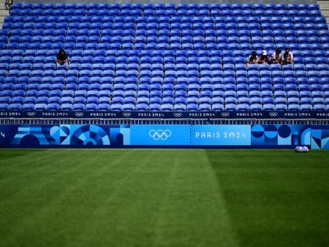 Football fans sit in empty tribunes prior to the women's group A football match betw