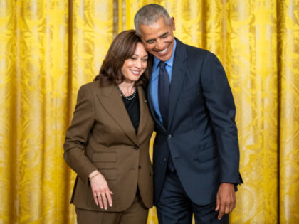 Former President Barack Obama hugs Vice President Kamala Harris during an Affordable Care