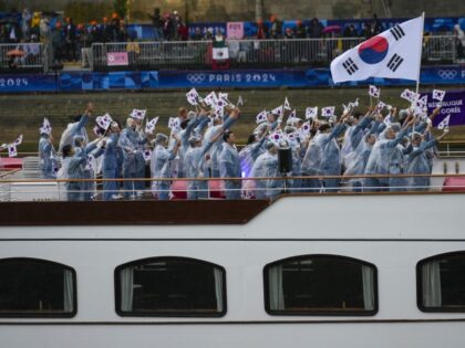 South Korea's Kim Seo-yeong and Woo Sang-hyeok travel with teammates along the Seine