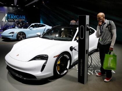 The Porsche Taycan Turbo, in white, and 4s, in blue, electric vehicles are shown at the Au