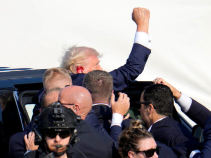 Republican presidential candidate former President Donald Trump pumps his fist as he is es
