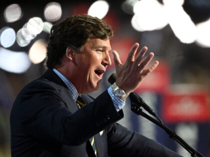 Tucker Carlson, founder of Tucker Carlson Network, speaks on stage on the fourth day of th