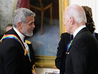 FILE - President Joe Biden shakes hands with actor, director and producer George Clooney d