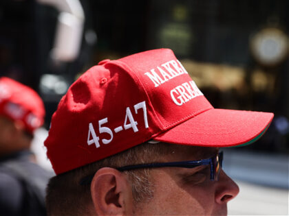 A person wearing Make America Great Again cap is seen in front of the Trump Tower in New Y