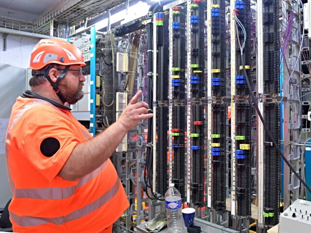 An employee checks the telephone connections of the various machines running on the networ