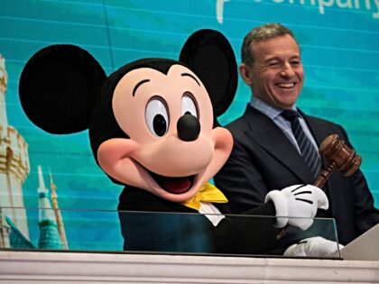 NEW YORK, NY - NOVEMBER 27: (L to R) Mickey Mouse and chief executive officer and chairman