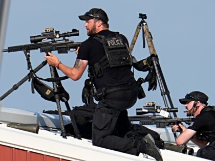 Police snipers return fire after shots were fired while Republican presidential candidate