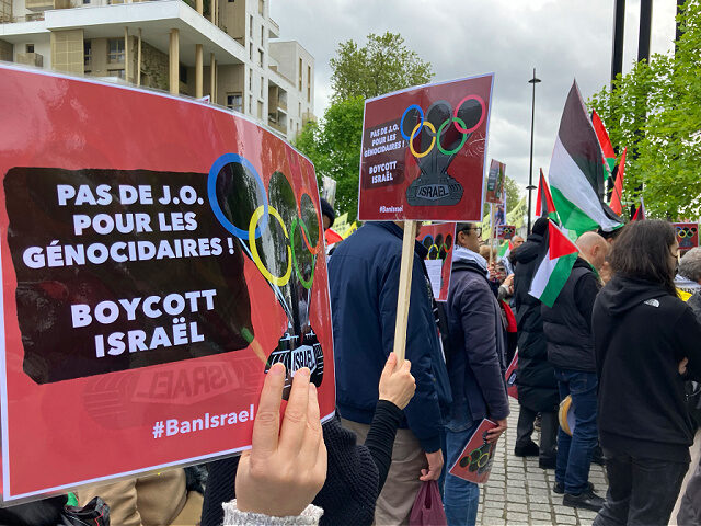 A demonstrator demanding the boycott of Israel during Olympic Games demonstrates with a po