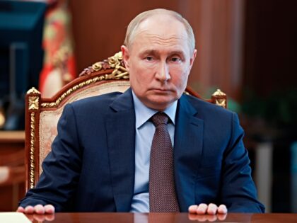 Russian President Vladimir Putin listens to the head of the chair of the Audit Chamber Bor