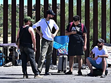 Migrants who walked into the US at Jacumba Hot Springs, California on June 5, 2024 await t
