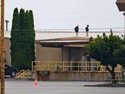 BUTLER, PENNSYLVANIA - JULY 14: Two FBI investigators scan the roof of AGR International I