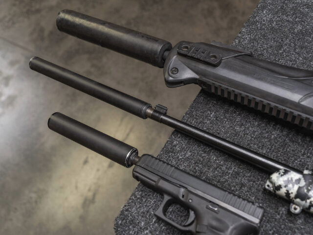 Firearms with a silencer, close-up photo. - stock photo