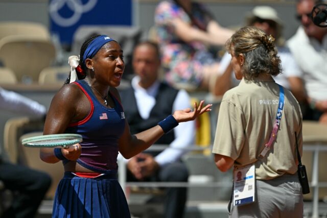 An emotional Coco Gauff speaks with tournament officials at the Paris Olympics tennis tour