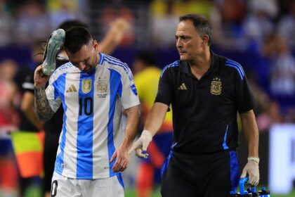 Argentina star Lionel Messi, at left walking off the field after an ankle injury in the Co