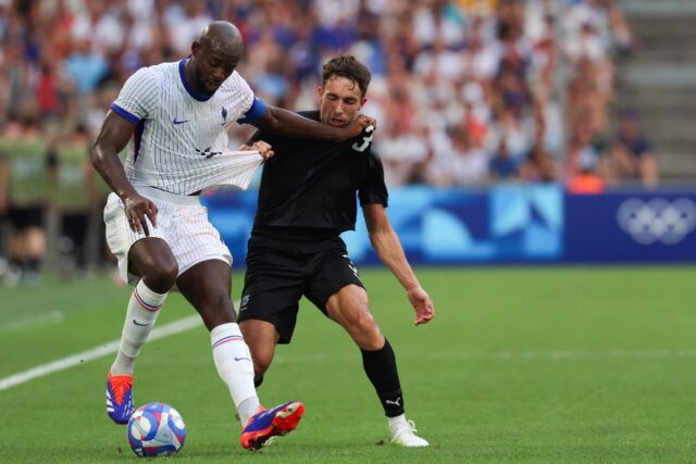 France's Jean-Philippe Mateta (L) in action against New Zealand on Tuesday