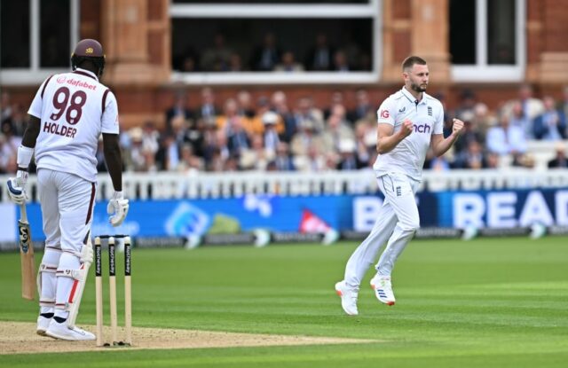 Key wicket: England's Gus Atkinson (R) celebrates after dismissing West Indies' Jason Hold