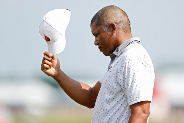 Third-round leader Jhonattan Vegas of Venezuela tips his cap to the crowd on the 18th gree