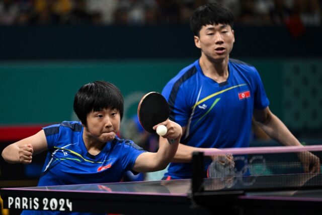 North Korea's Kim Kum Yong (L) and Ri Jong Sik in the mixed doubles