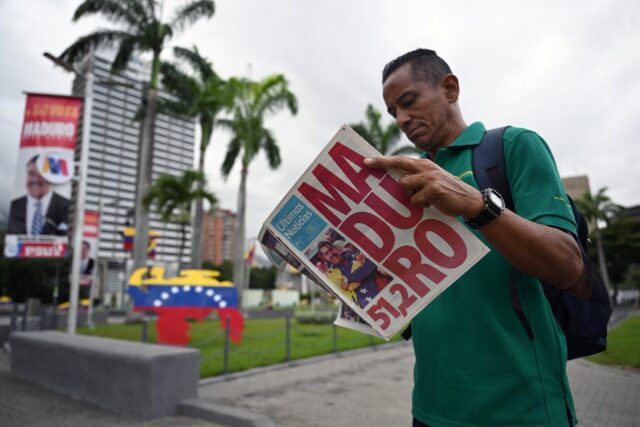 A man reads a newspaper in Caracas on July 29, 2024, a day after the Venezuelan presidenti