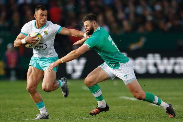 South African Jesse Kriel (L) hands off fellow centre Robbie Henshaw of Ireland during the