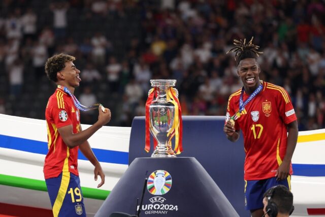 Spain wingers Lamine Yamal (L) and Nico Williams celebrate on the podium after winning Eur