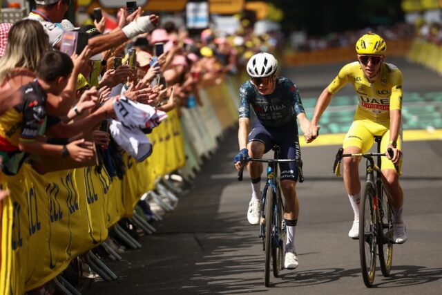 Tadej Pogacar in yellow takes the day's winner Jonas Vingegaard's hand