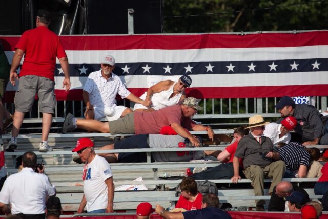 Trump supporters are seen laying in the stands after shots were fired at Republican candid