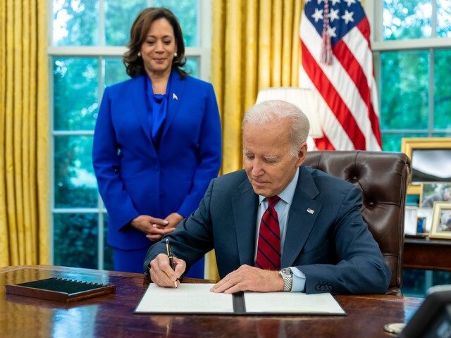 President Joe Biden, joined by Vice President Kamala Harris, signs an Executive Order to S