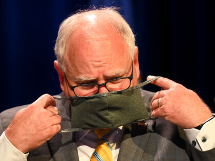 Minnesota Gov. Tim Walz put his face mask at the conclusion of a press conference Thursday