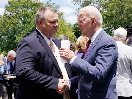 President Joe Biden speaks with Sen. Jon Tester, D-Mont., Thursday June 24, 2021, outside