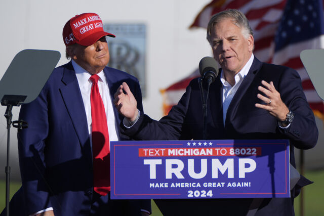 Republican presidential candidate former President Donald Trump listens as Michigan Senate