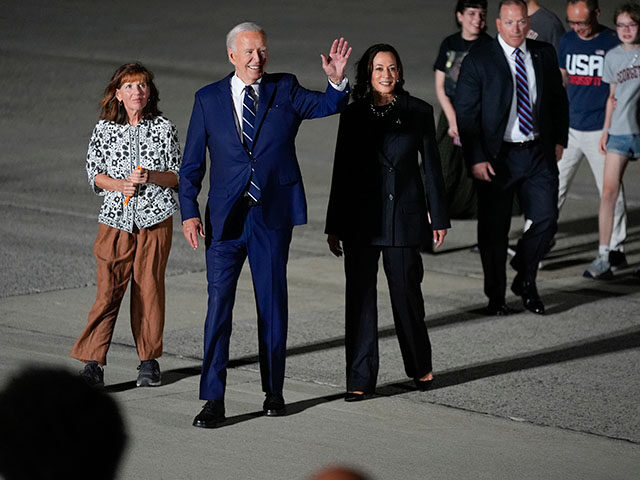 President Joe Biden and Vice President Kamala Harris walks with Ella Milman, left, mother