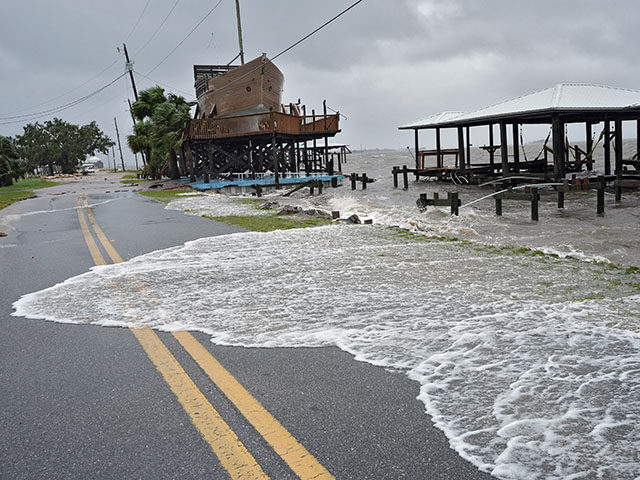 Storm surge breaks over a small sea wall near boat docks, Monday, Aug. 5, 2024, in Horsesh