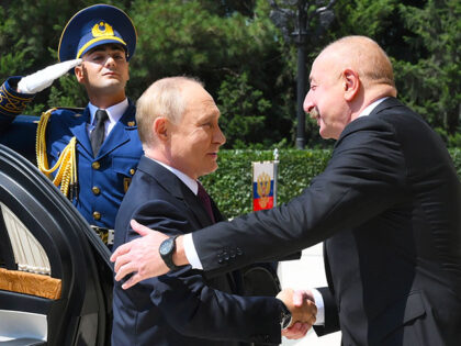 Azerbaijani President Ilham Aliyev, right, greets Russian President Vladimir Putin, left,