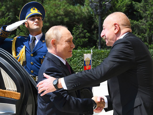 Azerbaijani President Ilham Aliyev, right, greets Russian President Vladimir Putin, left,