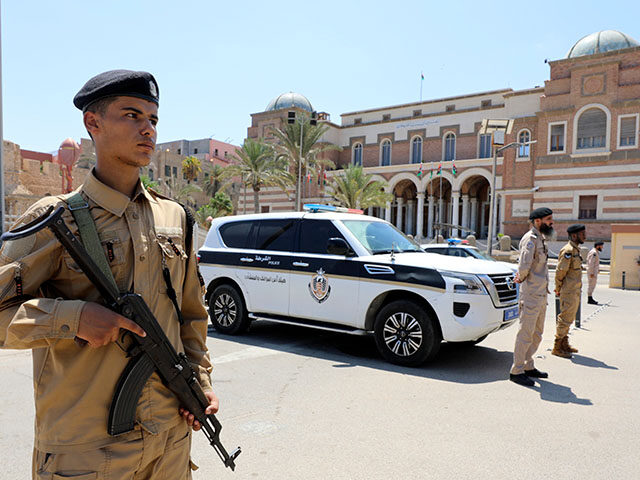 Libyan soldiers guard the Central Bank headquarters in Tripoli, Libya, Tuesday, Aug. 27, 2