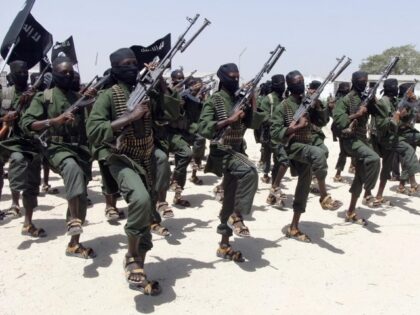 FILE - Hundreds of newly trained al-Shabab fighters perform military exercises in the Lafo