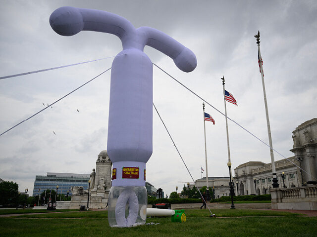 A 20-foot (6-meter) tall inflatable intrauterine device (IUD) stands outside of Union Stat