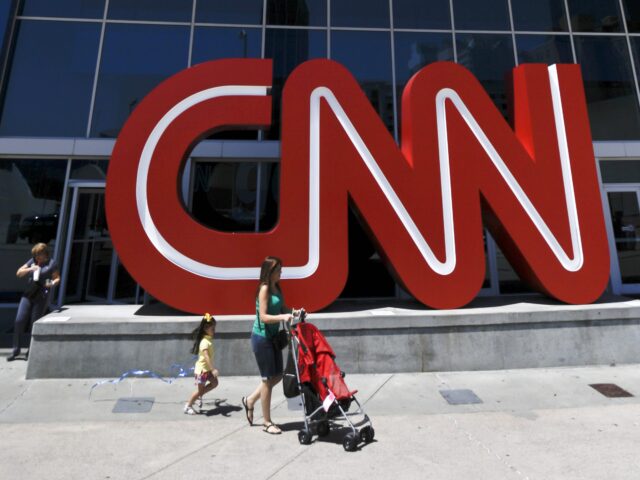 Pedestrians pass the entrance to CNN headquarters, Tuesday, Aug. 26, 2014, in Atlanta. The