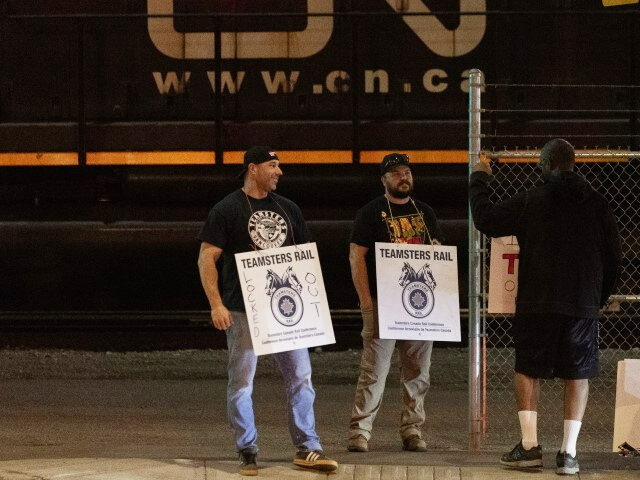 NORTH VANCOUVER, BRITISH COLUMBIA - AUGUST 21: Teamsters union members hold picket signs a