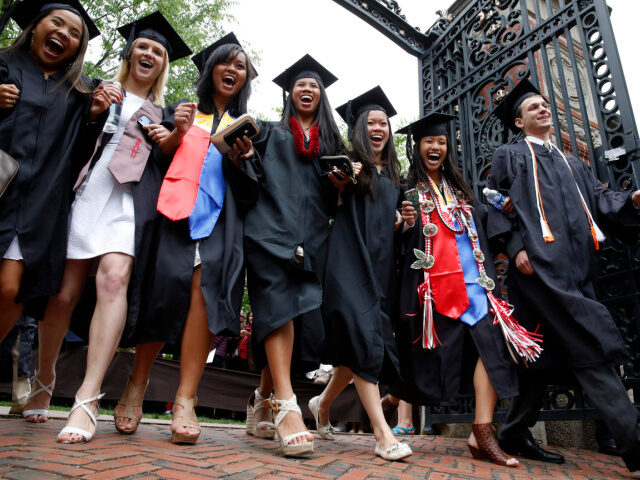 Brown University graduates pass through the Van Winkle Gates during the procession before