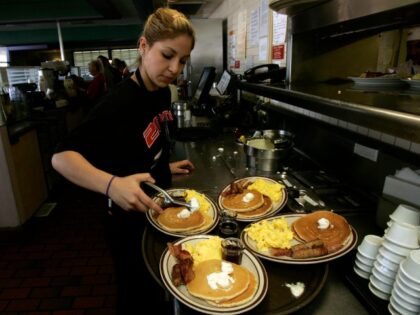 Gaby Estrella (Cq), prepares a tray of Grand Slam breakfast at Denny's Restaurant in Santa