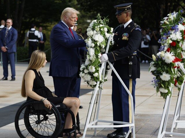 Republican presidential nominee, former U.S. President Donald Trump lays a wreath alongsid