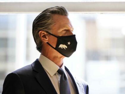 Gov. Gavin Newsom listens to speakers before addressing volunteers in San Francisco, Tuesd