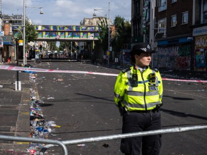 LONDON, ENGLAND - AUGUST 30: A police officer stands by the cordon at the scene of yesterd