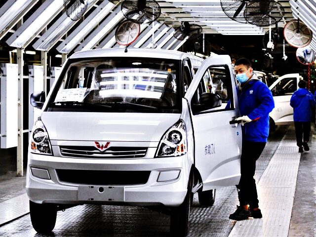 QINGDAO, CHINA - JANUARY 31, 2023 - Workers at a workshop check a car that is about to rol